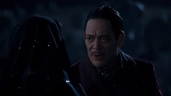 Movie still from “Addams Family Values” (1993), directed by Barry Sonnenfeld – A man with a mustache looking into a mirror; Close Up shot, Over the shoulder angle