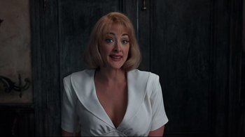 Movie still from “Addams Family Values” (1993), directed by Barry Sonnenfeld – A woman in a white dress is looking at the camera; Close Up shot, Over the shoulder angle