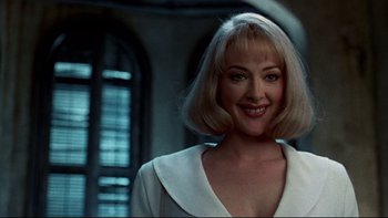 Movie still from “Addams Family Values” (1993), directed by Barry Sonnenfeld – A woman with blonde hair wearing a white dress; Close Up shot, Low angle