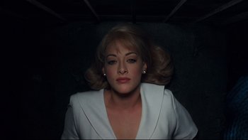 Movie still from “Addams Family Values” (1993), directed by Barry Sonnenfeld – A person wearing a white jacket; Close Up shot, Overhead angle