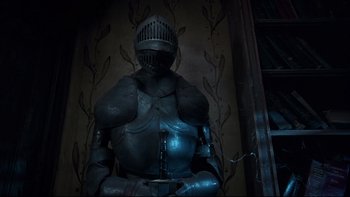 Movie still from “Addams Family Values” (1993), directed by Barry Sonnenfeld – A man in a suit of armor stands in front of a wall; Medium shot, Low angle