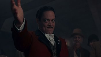Movie still from “Addams Family Values” (1993), directed by Barry Sonnenfeld – A man in a red jacket and a black hat; Close Up shot, Low angle
