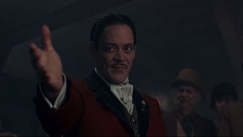Movie still from “Addams Family Values” (1993), directed by Barry Sonnenfeld – A man in a red jacket and a mustache; Close Up shot, Low angle