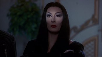 Movie still from “Addams Family Values” (1993), directed by Barry Sonnenfeld – A person wearing a costume; Close Up shot, Over the shoulder angle