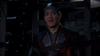 Movie still from “Addams Family Values” (1993), directed by Barry Sonnenfeld – A man with a beard and a hat is standing up; Medium shot, High angle