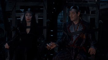 Movie still from “Addams Family Values” (1993), directed by Barry Sonnenfeld – A man and a woman dressed in costume; Medium shot, High angle