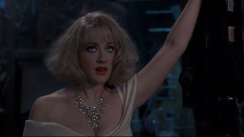 Movie still from “Addams Family Values” (1993), directed by Barry Sonnenfeld – A person wearing a necklace; Close Up shot, Over the shoulder angle