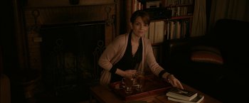 Movie still from “Admission” (2013), directed by Paul Weitz – A woman sitting at a table with a tray of tea; Medium shot, High angle