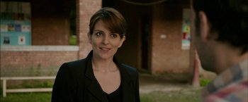 Movie still from “Admission” (2013), directed by Paul Weitz – A person wearing a suit; Close Up shot, Over the shoulder angle