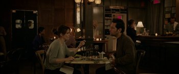 Movie still from “Admission” (2013), directed by Paul Weitz – A man and a woman sitting at a table in a restaurant; Medium shot, Over the shoulder angle