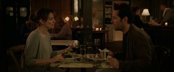 Movie still from “Admission” (2013), directed by Paul Weitz – A man and a woman sitting at a table with wine glasses; Medium shot, Over the shoulder angle