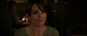 Movie still from “Admission” (2013), directed by Paul Weitz – A person wearing a gray t - shirt; Close Up shot, Over the shoulder angle