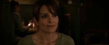 Movie still from “Admission” (2013), directed by Paul Weitz – A person wearing a gray t - shirt; Close Up shot, Over the shoulder angle