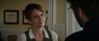Movie still from “Admission” (2013), directed by Paul Weitz – A woman in a white shirt and a gray vest; Close Up shot, Over the shoulder angle