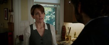 Movie still from “Admission” (2013), directed by Paul Weitz – A woman standing in front of a window in a kitchen; Close Up shot, Over the shoulder angle