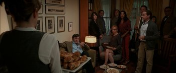 Movie still from “Admission” (2013), directed by Paul Weitz – A group of people sitting around a living room; Wide shot, High angle