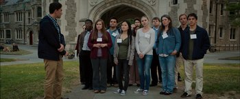Movie still from “Admission” (2013), directed by Paul Weitz – A group of young people standing in front of a building; Wide shot, High angle