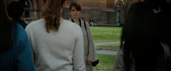Movie still from “Admission” (2013), directed by Paul Weitz – A woman standing next to two other women; Medium shot, Over the shoulder angle