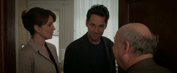 Movie still from “Admission” (2013), directed by Paul Weitz – Two men and a woman talking to each other in front of a window; Medium shot, Over the shoulder angle