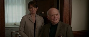 Movie still from “Admission” (2013), directed by Paul Weitz – A man and a woman standing next to each other; Medium shot, Over the shoulder angle