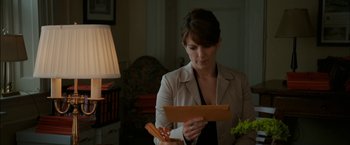 Movie still from “Admission” (2013), directed by Paul Weitz – A woman is looking down at a piece of paper; Close Up shot, Over the shoulder angle