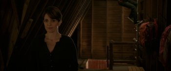 Movie still from “Admission” (2013), directed by Paul Weitz – A woman standing in front of a wooden wall; Medium shot, Over the shoulder angle