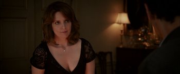 Movie still from “Admission” (2013), directed by Paul Weitz – A woman in a black dress in front of a lamp; Close Up shot, Over the shoulder angle