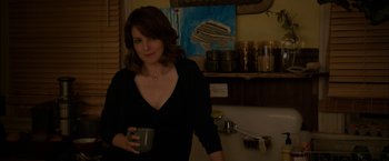 Movie still from “Admission” (2013), directed by Paul Weitz – A woman holding a coffee mug in a kitchen; Medium shot, Over the shoulder angle