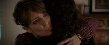 Movie still from “Admission” (2013), directed by Paul Weitz – A person hugging a person; Close Up shot, Over the shoulder angle