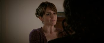 Movie still from “Admission” (2013), directed by Paul Weitz – A person sitting at a table; Close Up shot, Over the shoulder angle