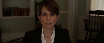 Movie still from “Admission” (2013), directed by Paul Weitz – A person wearing a suit and tie; Close Up shot, Over the shoulder angle