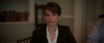 Movie still from “Admission” (2013), directed by Paul Weitz – A person wearing a suit and tie; Close Up shot, Over the shoulder angle