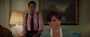 Movie still from “Admission” (2013), directed by Paul Weitz – A man and a woman sitting in front of a painting; Medium shot, Over the shoulder angle