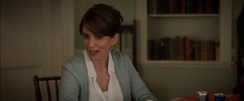 Movie still from “Admission” (2013), directed by Paul Weitz – A person sitting at a table; Close Up shot, Over the shoulder angle