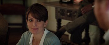 Movie still from “Admission” (2013), directed by Paul Weitz – A person sitting in a chair; Close Up shot, Over the shoulder angle