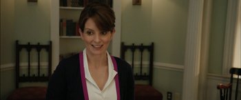 Movie still from “Admission” (2013), directed by Paul Weitz – A woman with short brown hair wearing a white shirt and a black jacket; Close Up shot, Over the shoulder angle