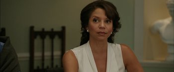 Movie still from “Admission” (2013), directed by Paul Weitz – A woman in a white shirt is looking at the camera; Close Up shot, Over the shoulder angle