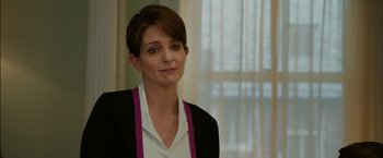 Movie still from “Admission” (2013), directed by Paul Weitz – A woman with short brown hair wearing a white shirt and a black jacket; Close Up shot, Over the shoulder angle