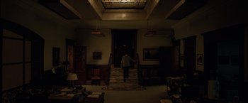 Movie still from “Admission” (2013), directed by Paul Weitz – A man walking down the stairs in a dark room; Extreme Wide shot, High angle