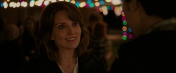 Movie still from “Admission” (2013), directed by Paul Weitz – A person smiling at the camera; Close Up shot, Over the shoulder angle