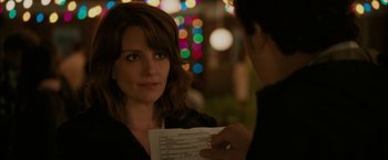 Movie still from “Admission” (2013), directed by Paul Weitz – A woman is holding a piece of paper and looking at a man; Close Up shot, Over the shoulder angle