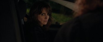Movie still from “Admission” (2013), directed by Paul Weitz – A woman sitting in the back seat of a car; Close Up shot, Over the shoulder angle