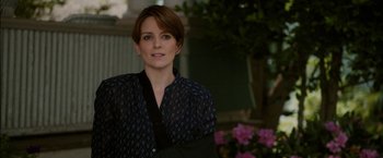 Movie still from “Admission” (2013), directed by Paul Weitz – A woman with short brown hair wearing a black shirt; Close Up shot, Over the shoulder angle