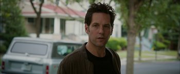 Movie still from “Admission” (2013), directed by Paul Weitz – A man that is standing in front of a house; Close Up shot, Over the shoulder angle