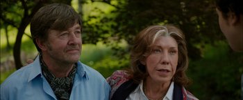 Movie still from “Admission” (2013), directed by Paul Weitz – A man and a woman standing next to each other in front of trees; Close Up shot, Over the shoulder angle