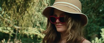 Movie still from “Adoration” (2019), directed by Fabrice du Welz – A woman wearing sunglasses and a hat; Close Up shot, Low angle