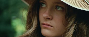 Movie still from “Adoration” (2019), directed by Fabrice du Welz – A person wearing a hat; Close Up shot, Low angle