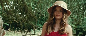Movie still from “Adoration” (2019), directed by Fabrice du Welz – A beautiful young lady wearing a sun hat; Close Up shot, Low angle