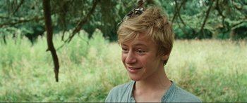Movie still from “Adoration” (2019), directed by Fabrice du Welz – A young man with a bird on his head; Close Up shot, Low angle