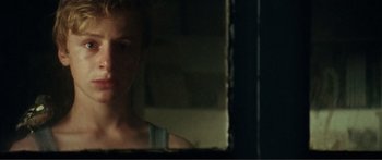 Movie still from “Adoration” (2019), directed by Fabrice du Welz – A woman looking in the mirror in a bathroom; Close Up shot, Over the shoulder angle